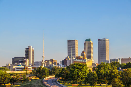 06-14-2020 Tulsa USA - View of downtown skyline from east in early morning with sun reflecting off historical art deco and modern buildings