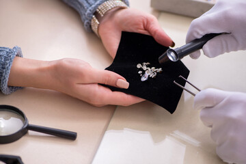 Male jeweler and female client at store