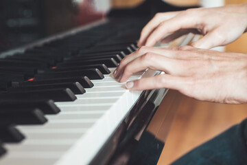 Obraz premium Playing piano at home, high angle view, blurry background.
