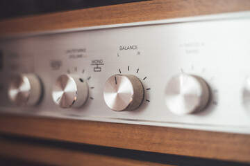 Silver wooden vintage amplifier: Close up of control knobs