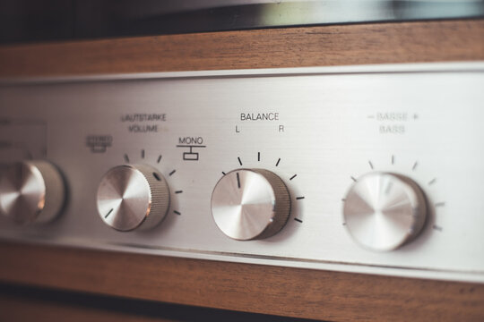 Silver wooden vintage amplifier: Close up of control knobs