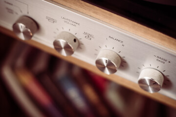 Fototapeta premium Silver wooden vintage amplifier: Close up of control knobs
