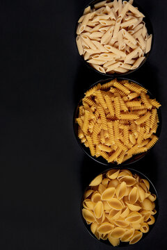 Various pasta. Cooking concept. Top view on dark beton background wuth copy space.