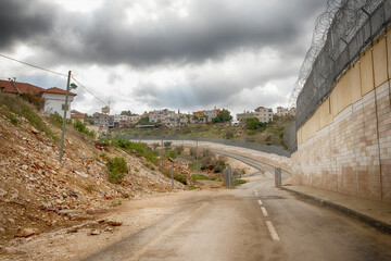View on Israeli settlement Shaarei Tikvah. On the right we see a fragment of a protective fence.