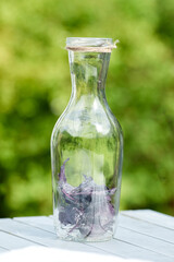 Delicious refreshing lemonade with basil, lime and strawberries. Summer drink with ice. Home made production.