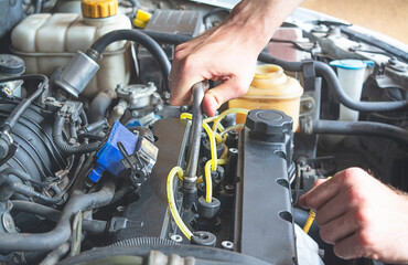 Auto mechanic hand with socket wrench. Car repair and maintenance. Close-up.