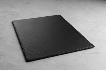 Slate Board on a grey background for product placement on the diagonal. - obrazy, fototapety, plakaty