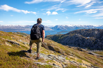 Happy man on hike to the Skogmo mountain in great summer weather, Nordland county
