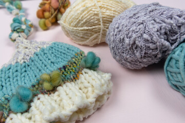 Fototapeta na wymiar knitting yarn and hand made elf hat on the table 