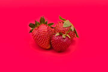 Fresh and juicy strawberries on red background