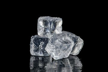 Ice cubes reflection on black table background