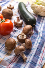 Raw  fresh brown crimini mushrooms and onion on wooden background. Ingredients for cooking