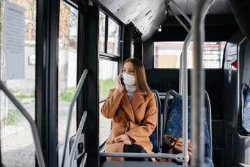 A young girl in a mask uses public transport alone, during a pandemic. Protection and prevention covid 19