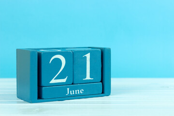 wooden calendar with the date of June 21 on a blue wooden background, World Humanism Day, World Hydrography Day, World Giraffe Day, World Handshake Day, Fathers Day