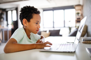 Boy spending time with notebook and modern technology