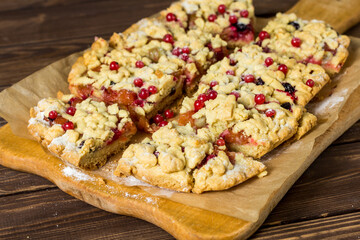 sliced ​​homemade grated pie with berries
