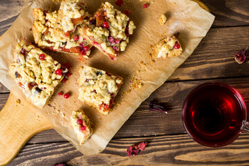 tasty breakfast. sliced ​​homemade grated pie with berries on a wooden board.