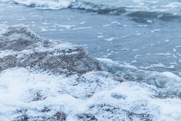 Pieces of ice drifting along the sand coast of Baltic sea. Winter fresh.