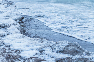 Pieces of ice drifting along the sand coast of Baltic sea. Winter fresh.