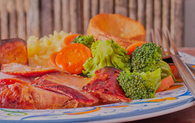 Smoked gammon dinner with vegetables, creamed potatoes and Yorkshire pudding.
