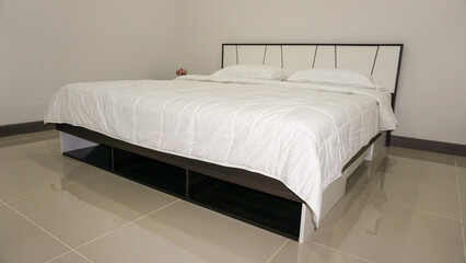 Fototapeta premium King size or Queen size bed with covers, duvet and pillows. Decorated bedroom furniture with walls, windows and curtains. Estate house gallery for sale equipped with furniture.