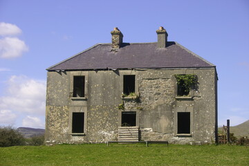 Old, derelict two-storey farmhouse located in countryside,  County Leitrim, Ireland