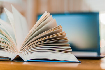 Open book lying on the table in the library