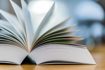Open book lying on the table in the library