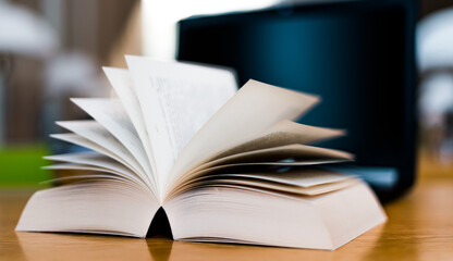 Open book lying on the table in the library