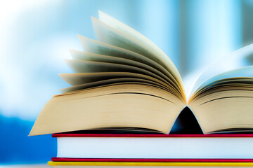 Open book lying on the table in the library