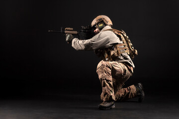 military special forces in uniform with weapons attack at night, elite troops, counter-terrorist against a dark background