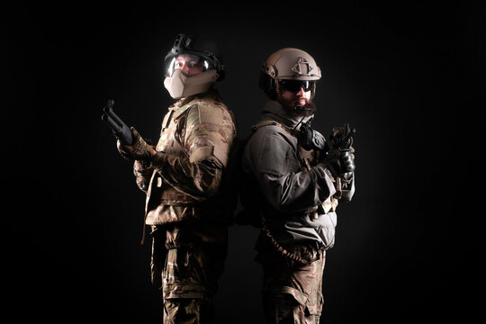 American special forces. two rangers in uniform with weapons stand together against a black background, portrait of two soldiers