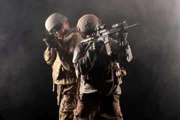 army of america. two soldiers in military equipment with weapons stand on a black background, a special forces team