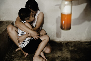 Crying young woman hugging her son.