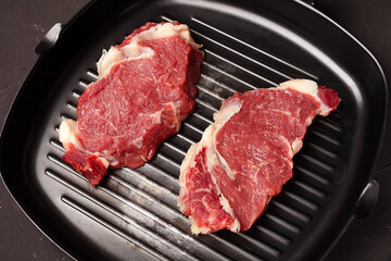 two steaks in a pan for grilling, close-up