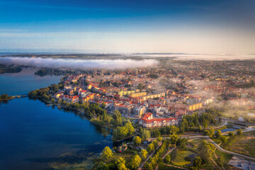 Foggy morning at the Elk Lake near Elk city. Masuria, Poland.