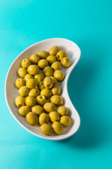 plate of olives on blue background