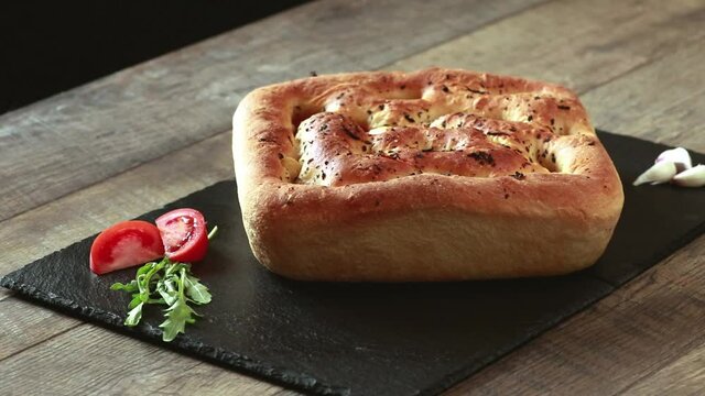 Italian focaccia with tomatoes, garlic and basil