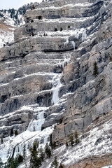 Fototapeta na wymiar Bridal Veil Falls in Provo Canyon with snow ice and evergreen trees in winter