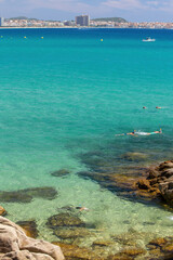 Beautiful coastal in Costa Brava of Spain with driver in transparent green water, near village Sant Antoni de Claonge