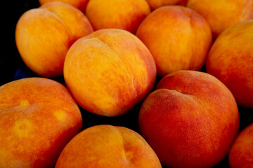 Fototapeta na wymiar Heap of Fresh Ripe Peaches For Sale on the Market