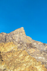 Peak of a rocky mountain with clear blue sky background in Provo Canyon Utah