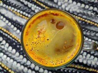 hot drink with foam in a glass cup