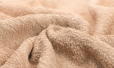 Fototapeta na wymiar Towel texture closeup. Soft beige color cotton towel backdrop, fabric background. Terry cloth bath or beach towels. Macro image