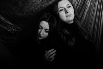Two sisters on a black background