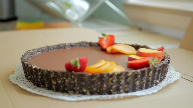Decorating chocolate cake with fruits, time lapse