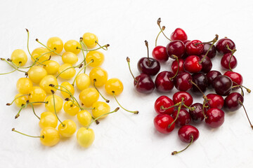 Fresh yellow and red cherry on white background