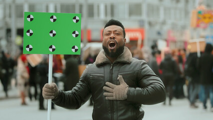 African American man. Empty banner. Hand wave. Track point. Copyspace. Blank board placard. Crowd people. Afro rebel. Revolution city street. Political rally fight. 