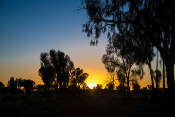 Naklejka na ściany i meble The Outback. Sunset over Uluru National Park in the Outback of Australia