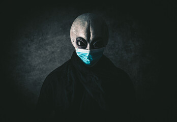 Alien creature with medical mask. Alternative concept about coronavirus